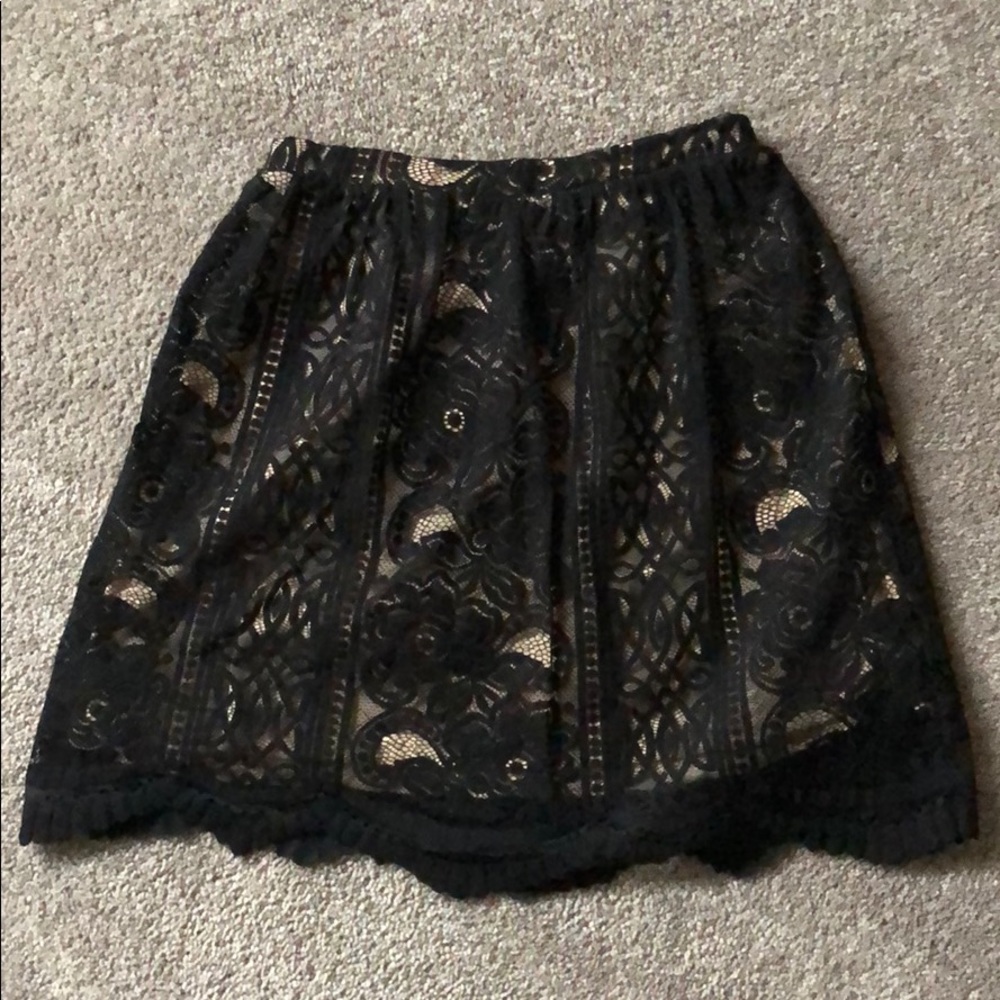 Black lace skirt With nude colored underlay.